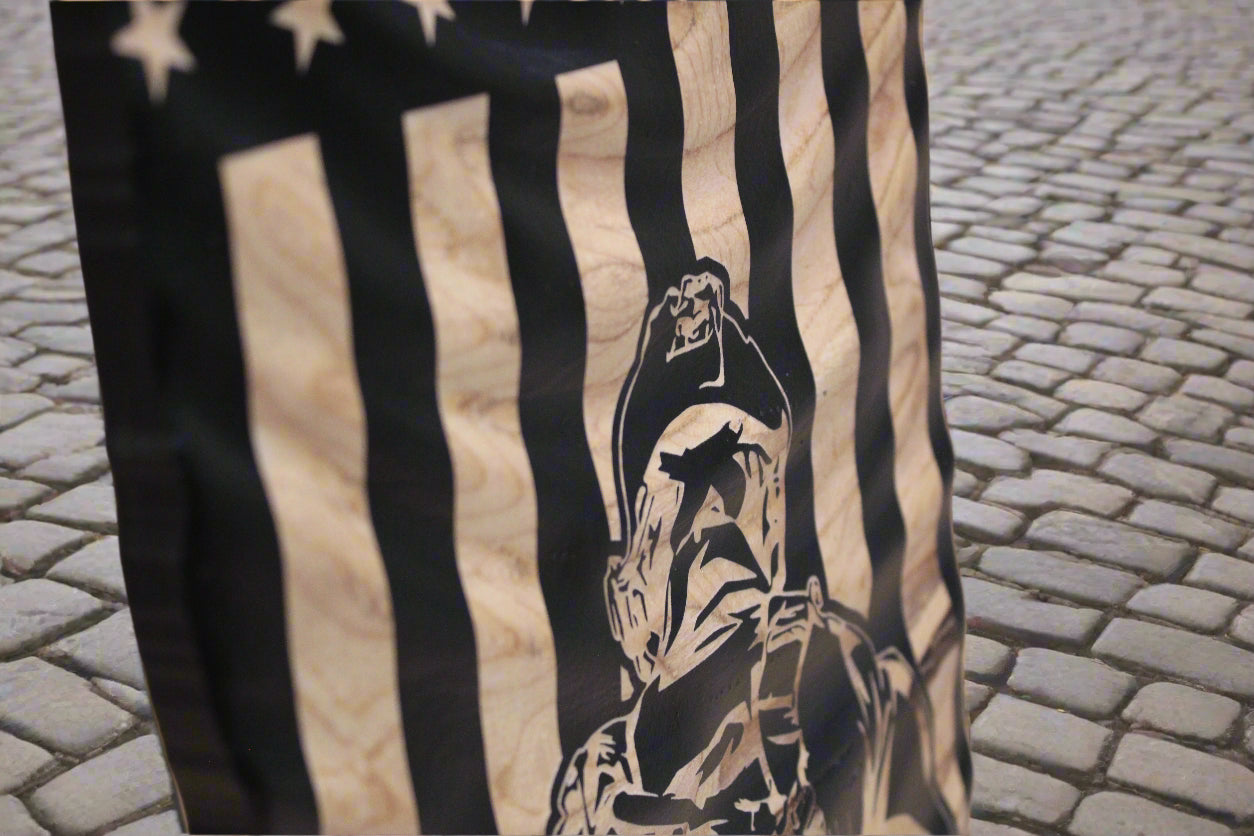 American flag with a black and white graphic of a person on a wooden surface