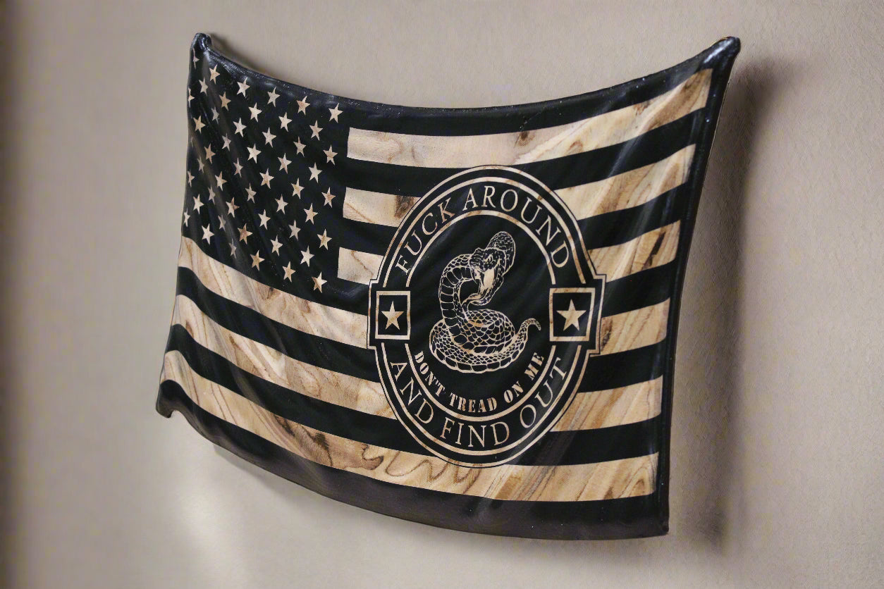 Wooden American flag with a snake design and text on a wooden surface