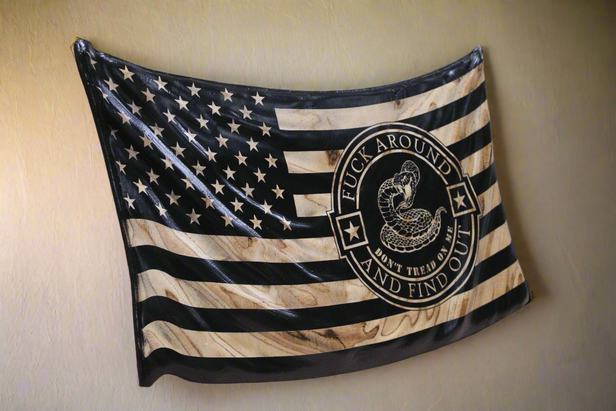 American flag with a black circle logo on a wooden surface