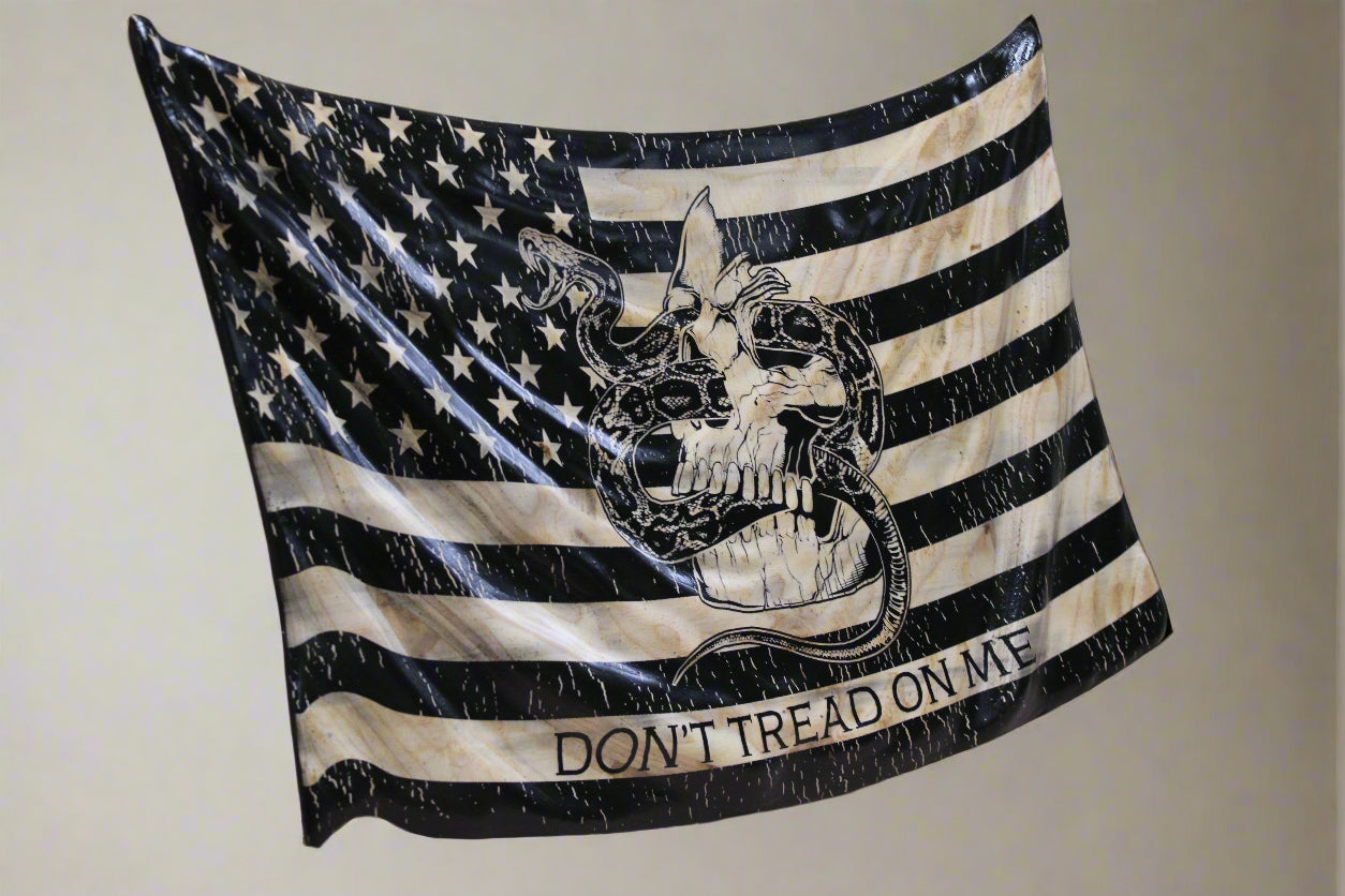 American flag with skull design and 'Don't Tread on Me' text on a wooden surface.