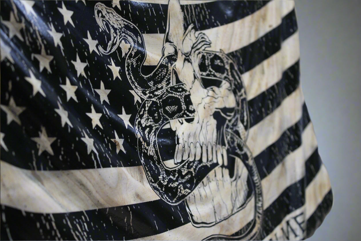 American flag with a skull and snake design on a black background