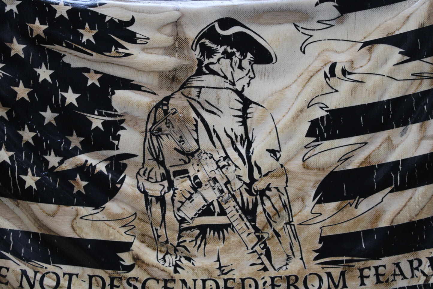 Flag with a black and white design of a soldier and text on a beige background