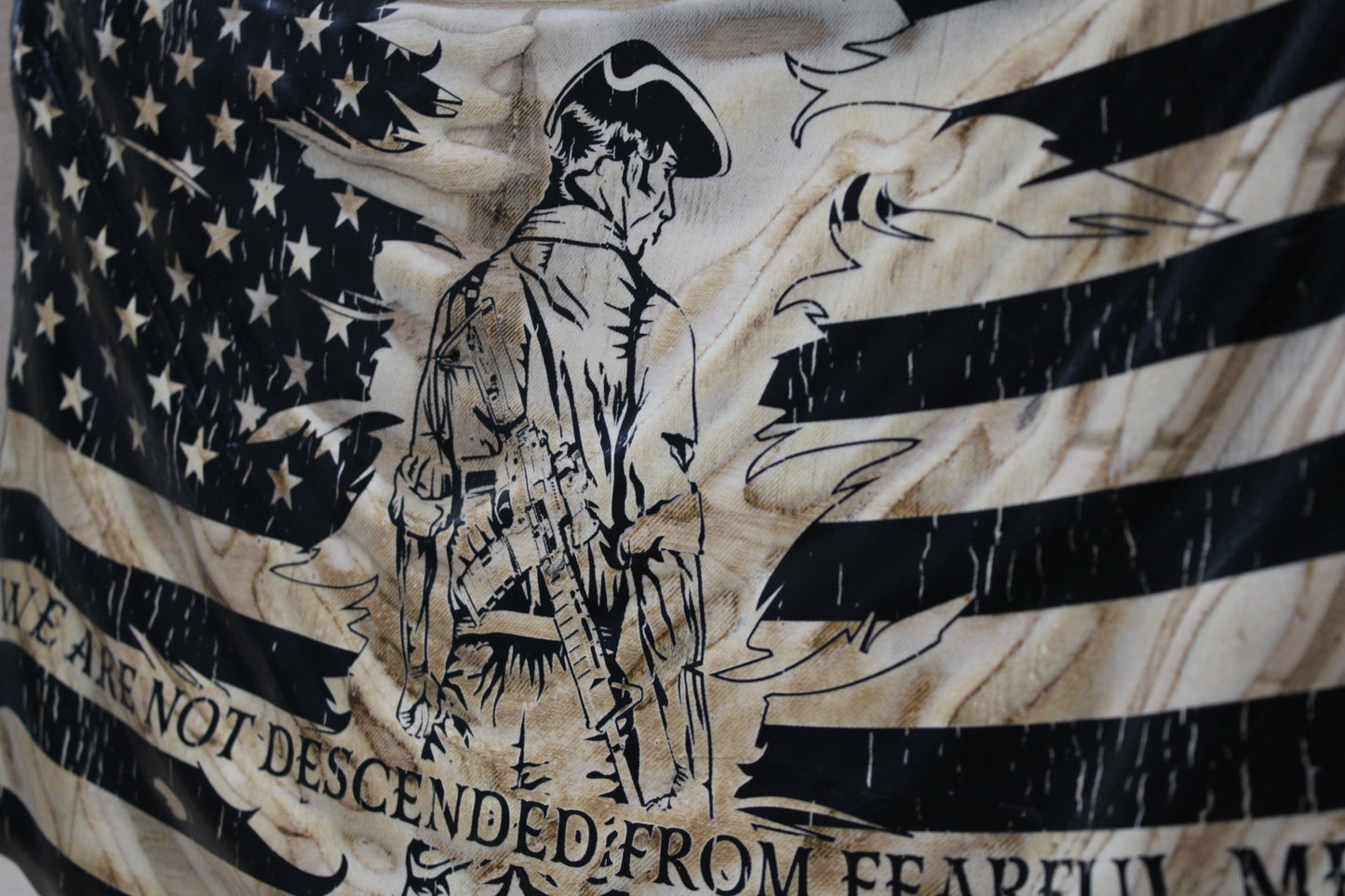 American flag with a black and white graphic of a soldier and text on a textured background