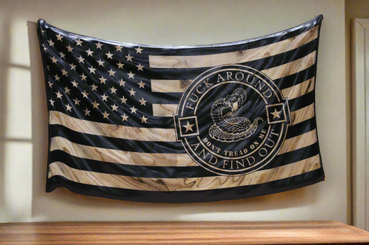 American flag with a snake emblem and text on a wooden surface